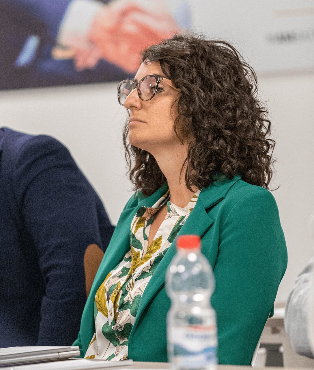 A participant listening attentively to a presentation at the Satech 2024 Sales Conference